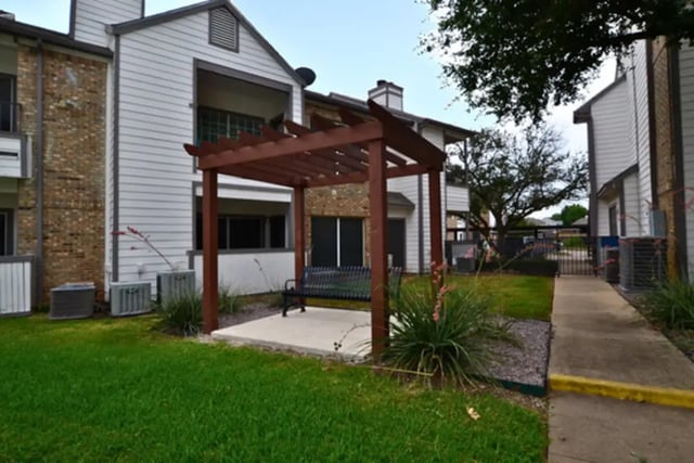 Pergola with bench outdoor seating area exterior at The Oaks of Arlington in Arlington Student Accommodation