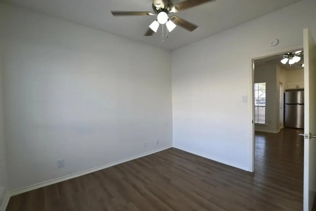 White walls wooden floor ceiling fans living room at The Oaks of Arlington in Arlington Student Accommodation