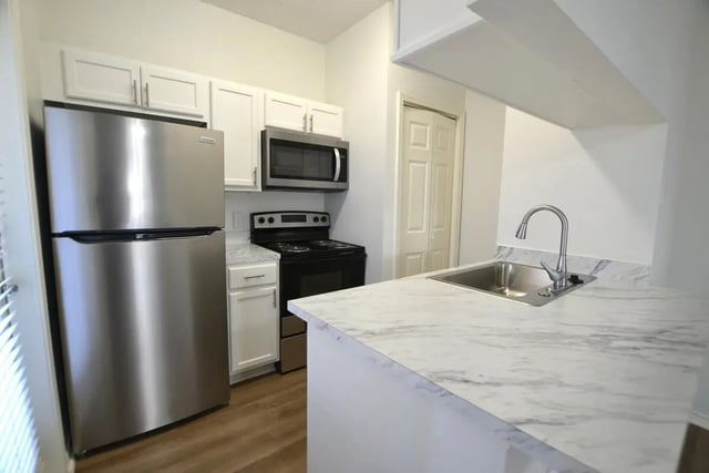 Stainless steel fridge stove microwave sink kitchen at The Oaks of Arlington in Arlington Student Accommodation