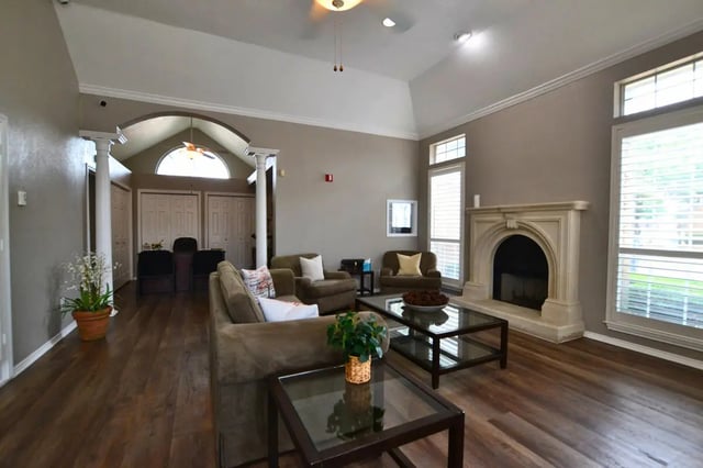 Sofa fireplace chairs coffee tables living room at The Oaks of Arlington in Arlington Student Accommodation