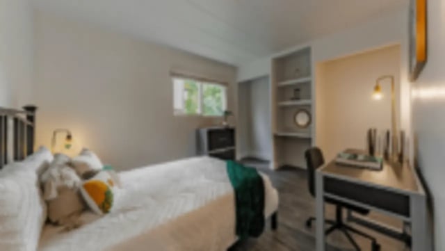 Bed with pillows desk with lamp bookshelf Bedroom at Victory at Burcham Place in East Lansing Student Accommodation