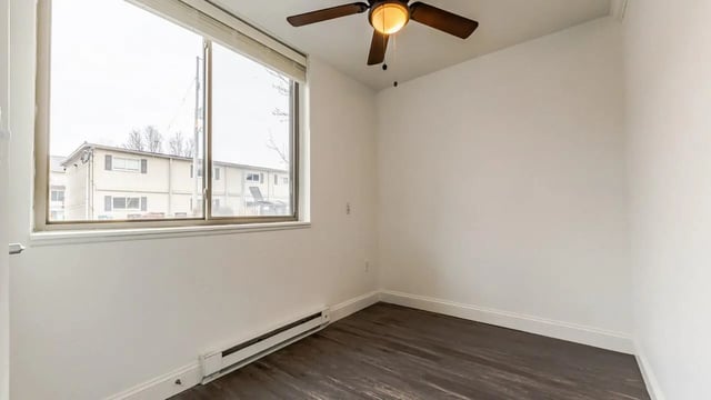 Empty room with ceiling fan and window bedroom at Victory at Burcham Place in East Lansing Student Accommodation