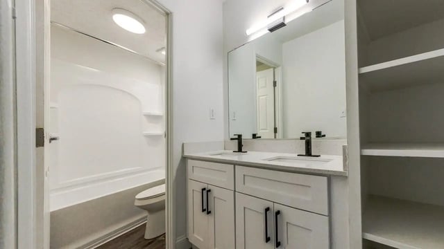 Double vanity toilet shower bath shelving bathroom at Victory at Burcham Place in East Lansing Student Accommodation