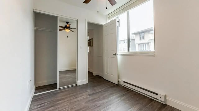 Mirrored closet and ceiling fan bedroom at Victory at Burcham Place in East Lansing Student Accommodation