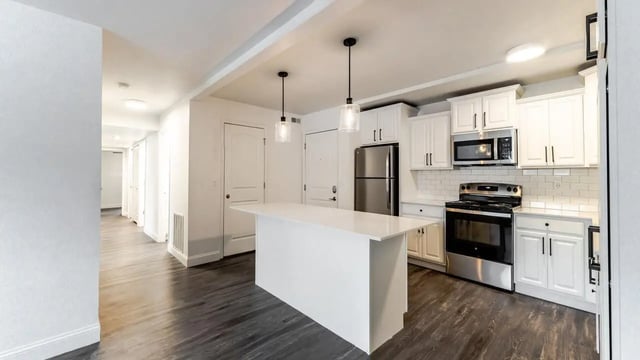 Modern kitchen with island stainless steel appliances kitchen at Victory at Burcham Place in East Lansing Student Accommodation