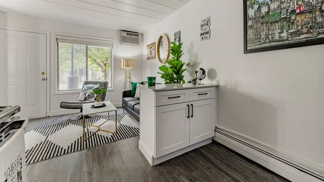 Leather sofa and chair white cabinet living room at Victory at Burcham Place in East Lansing Student Accommodation