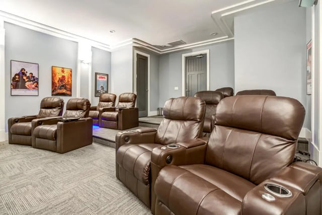 Brown leather recliner seats with cup holders Movie Room at The Nest at 4955 in Wilmington Student Accommodation