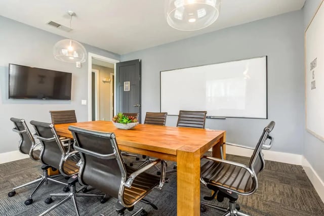 Meeting room table chairs TV whiteboard communal area at The Nest at 4955 in Wilmington Student Accommodation