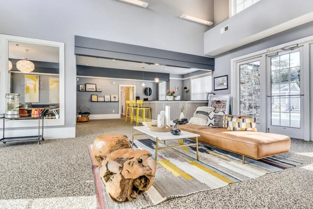 Leather chaise lounge with pillows living room at The Nest at 4955 in Wilmington Student Accommodation