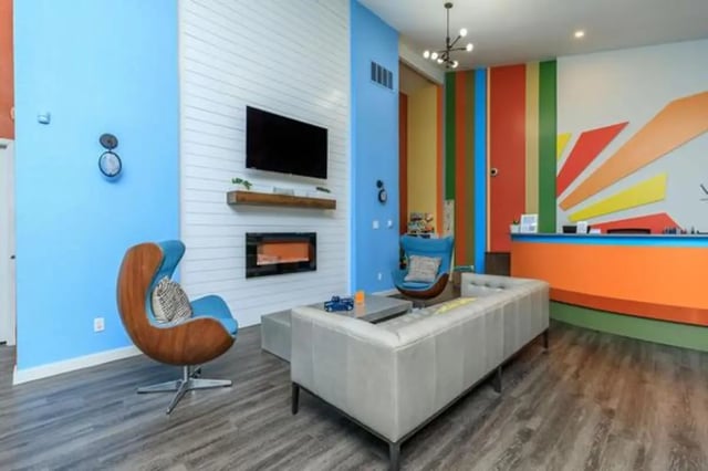 Sofa egg chairs fireplace TV reception desk living room at Villas at Alameda in Fort Worth Student Accommodation