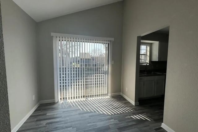 Sliding door blinds grey wood floor kitchen area Kitchen at Villas at Alameda in Fort Worth Student Accommodation