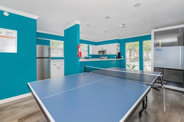 Ping pong tables kitchen area and refrigerator common area at Villas at Shadow Oaks in Austin Student Accommodation