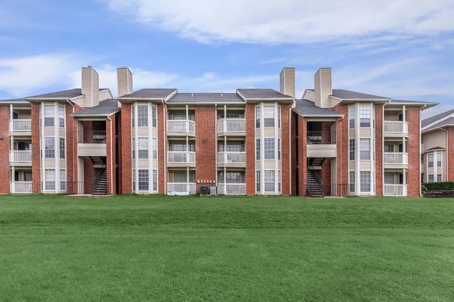 Brick apartment building with balconies exterior at Villas at Shadow Oaks in Austin Student Accommodation