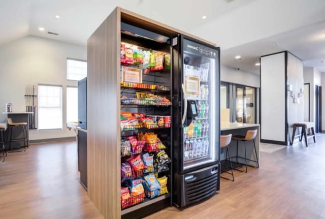 Snack vending machine with drinks and snacks common area at Collegiate Suites of Blacksburg in Blacksburg Student Accommodation
