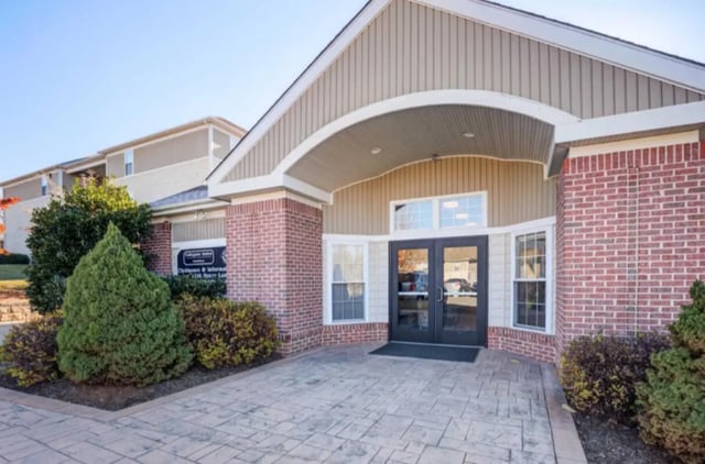 Entrance with double doors and landscaping exterior at Collegiate Suites of Blacksburg in Blacksburg Student Accommodation