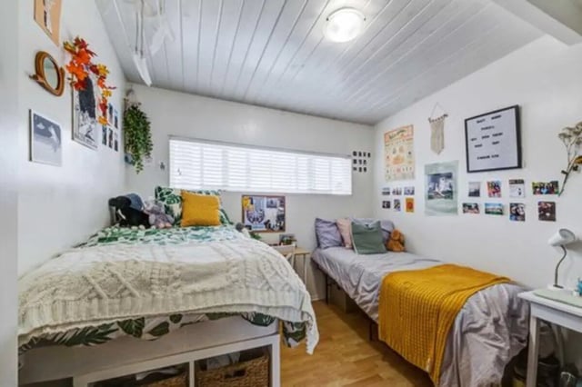Two beds with bedding and decor bedroom at Solis Isla Vista in Isla Vista Student Accommodation