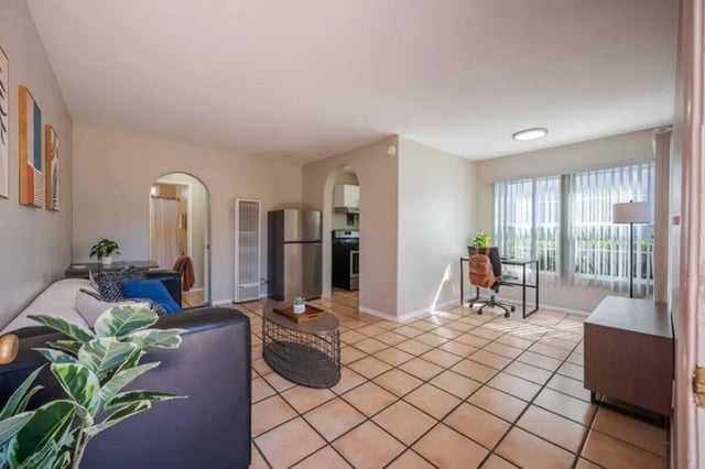 Sofa desk and kitchen living room at Solis Isla Vista in Isla Vista Student Accommodation