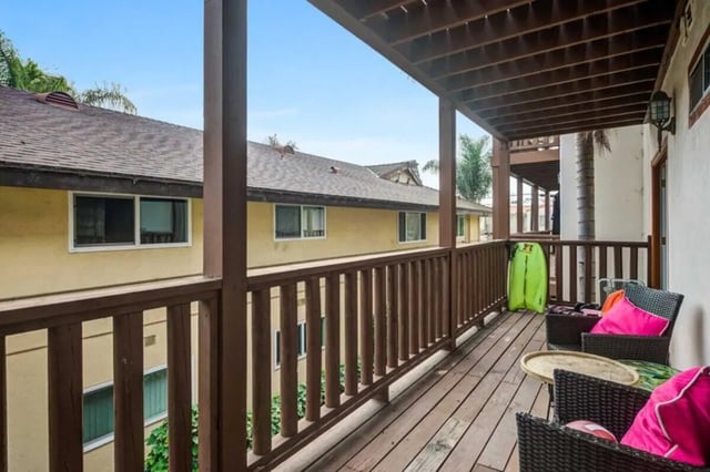 Wicker chairs neon board balcony exterior at Solis Isla Vista in Isla Vista Student Accommodation