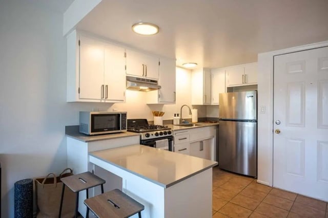 Kitchen with stainless steel appliances and counter seating Kitchen at Solis Isla Vista in Isla Vista Student Accommodation