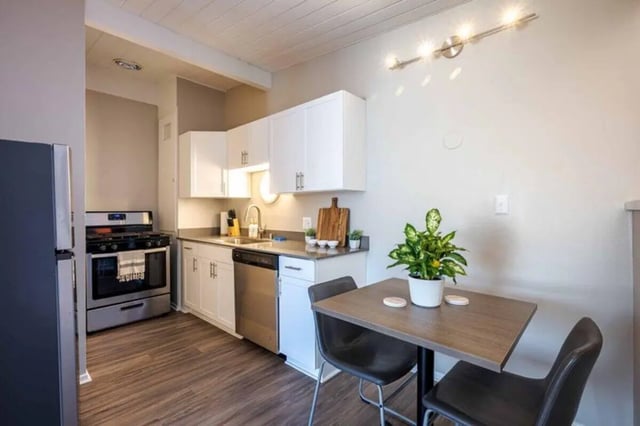 Stove cabinets sink dishwasher table chairs kitchen at Solis Isla Vista in Isla Vista Student Accommodation