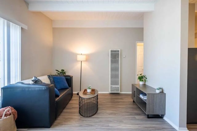 Sofa lamp plant coffee table living room at Solis Isla Vista in Isla Vista Student Accommodation