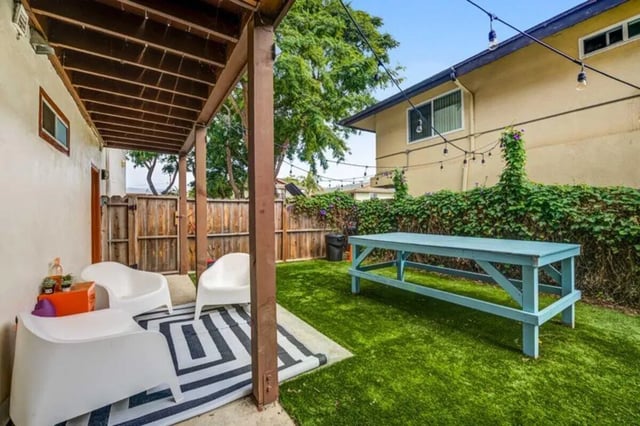 White chairs rug blue table outdoor area exterior at Solis Isla Vista in Isla Vista Student Accommodation