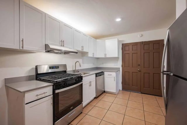White cabinets stainless steel stove dishwasher kitchen at Solis Isla Vista in Isla Vista Student Accommodation