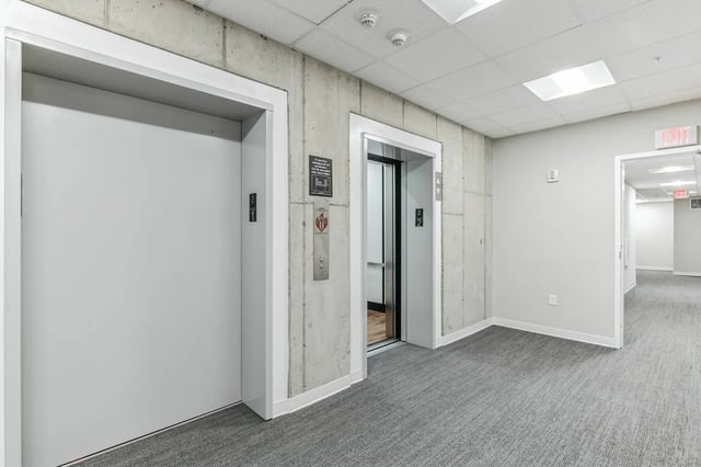 Elevator doors concrete walls carpeted hallway Corridor at The Ross Salisbury in Salisbury Student Accommodation