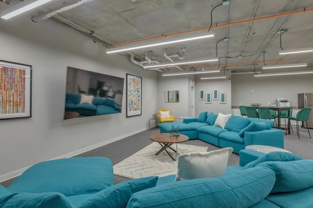 Large turquoise sectional sofa coffee table living room at The Ross Salisbury in Salisbury Student Accommodation