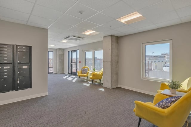 Mailboxes yellow chairs plant and window common area at The Ross Salisbury in Salisbury Student Accommodation