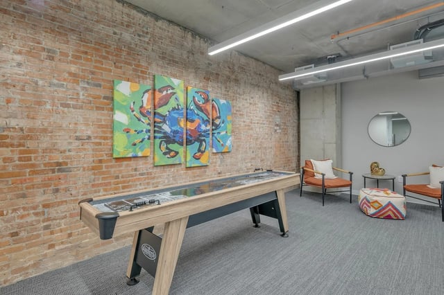 Shuffleboard table with crab art and seating living area at The Ross Salisbury in Salisbury Student Accommodation