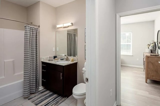Bathroom with shower vanity toilet and adjacent bedroom. at Avoca in Louisville Student Accommodation