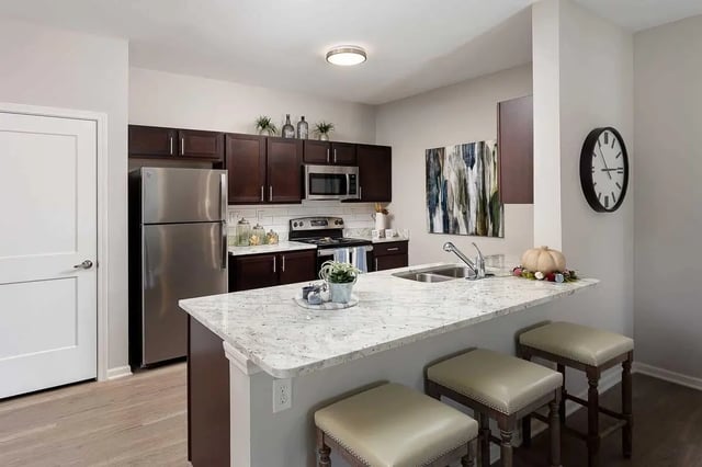 Modern kitchen with granite island and stools kitchen at Avoca in Louisville Student Accommodation