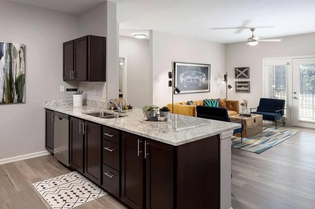 Kitchen island with cabinets and sink living room living room at Avoca in Louisville Student Accommodation