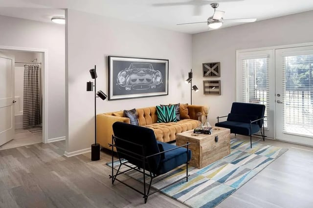 Sofa chairs rug artwork and doorway living room at Avoca in Louisville Student Accommodation