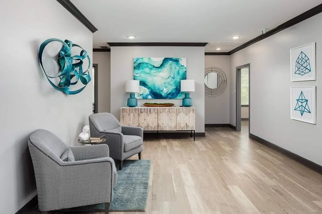 Two gray chairs abstract art console table entryway at Avoca in Louisville Student Accommodation