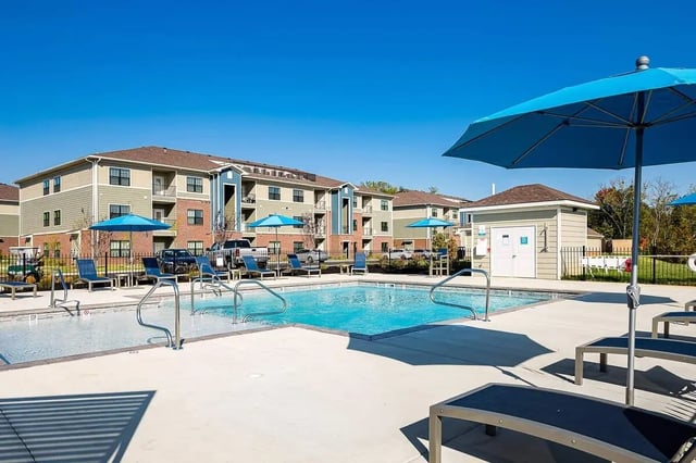 Swimming pool with lounge chairs and buildings exterior at Avoca in Louisville Student Accommodation