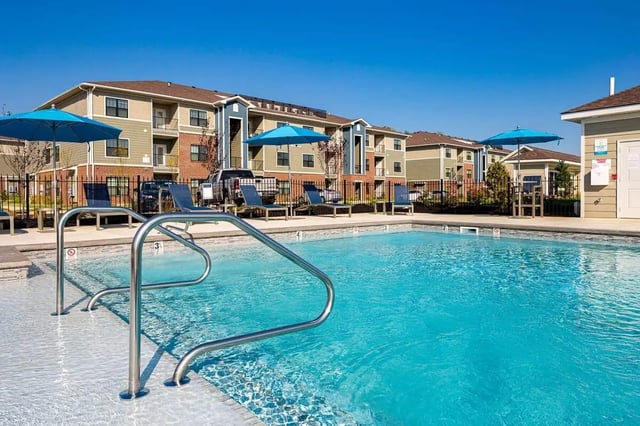 Blue umbrellas lounge chairs by pool Exterior at Avoca in Louisville Student Accommodation