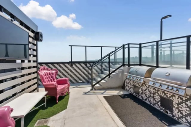 Pink chairs grilling station and TV outdoor area at Steelhaven Birmingham in Birmingham Student Accommodation