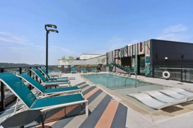 Deck chairs by pool and building exterior at Steelhaven Birmingham in Birmingham Student Accommodation