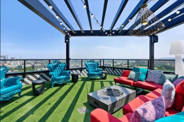 Rooftop lounge with colorful seating and fire pit exterior at Steelhaven Birmingham in Birmingham Student Accommodation