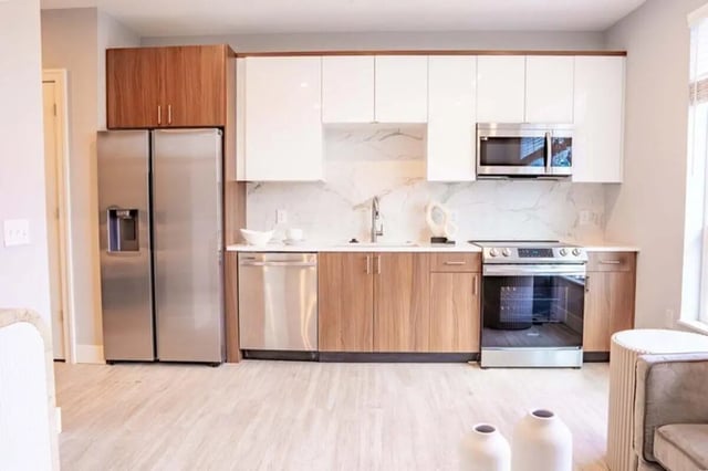 Modern kitchen with stainless steel appliances and wood cabinets kitchen at 8th and High Columbus in Columbus Student Accommodation