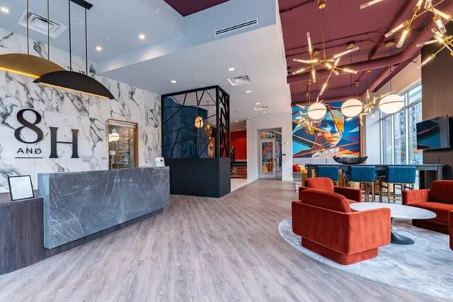 Marble reception desk seating area and modern art lobby at 8th and High Columbus in Columbus Student Accommodation