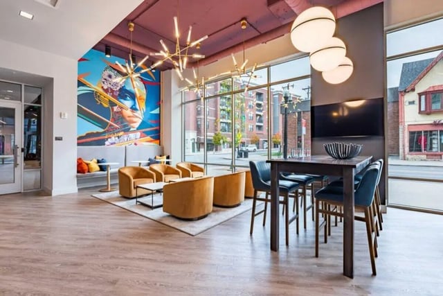 Colorful mural grey sofa modern chairs lounge area at 8th and High Columbus in Columbus Student Accommodation
