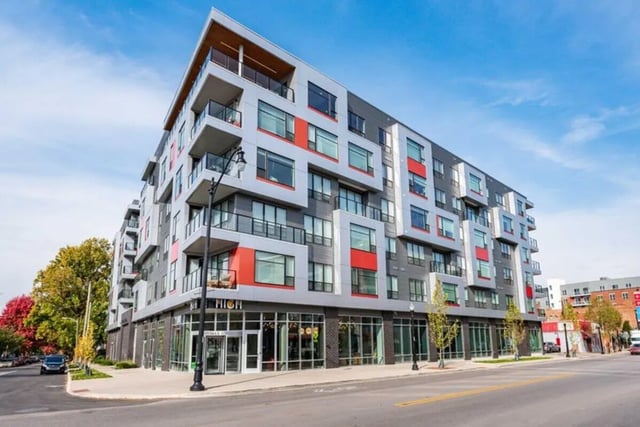 Modern apartment building with balconies and red accents exterior at 8th and High Columbus in Columbus Student Accommodation