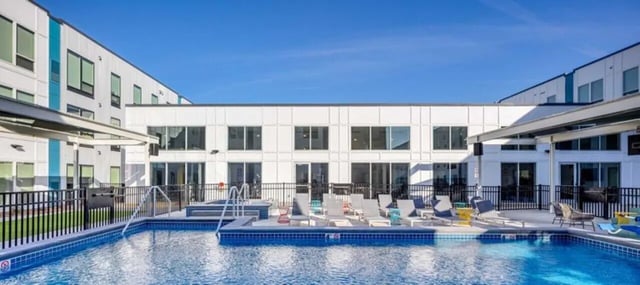 Pool lounge chairs and jacuzzi exterior at Proxi Lawrence in Lawrence Student Accommodation