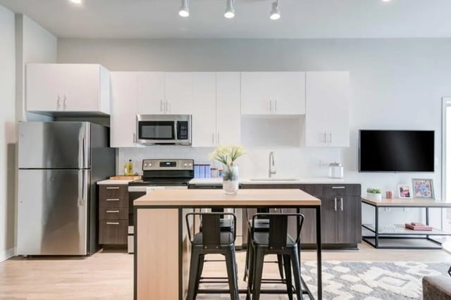 Stainless steel fridge microwave stove island kitchen at Proxi Lawrence in Lawrence Student Accommodation
