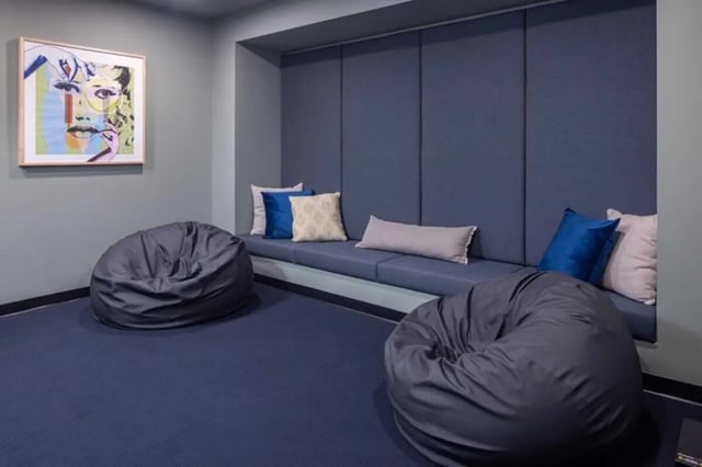 Beanbags artwork and blue built-in sofa living room at Proxi Lawrence in Lawrence Student Accommodation