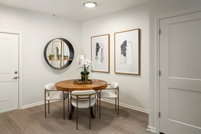 Round table with chairs artwork and mirror dining area at Frontgate in Louisville Student Accommodation