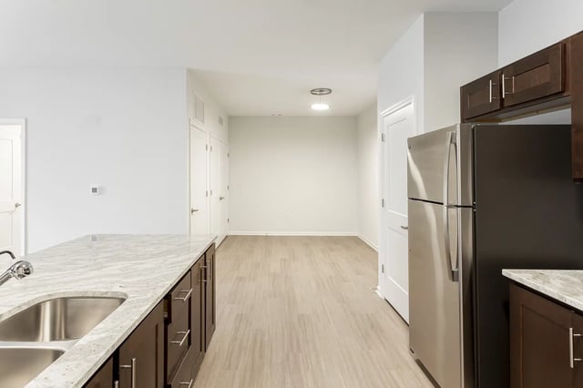 Stainless steel refrigerator and granite countertop kitchen at Frontgate in Louisville Student Accommodation